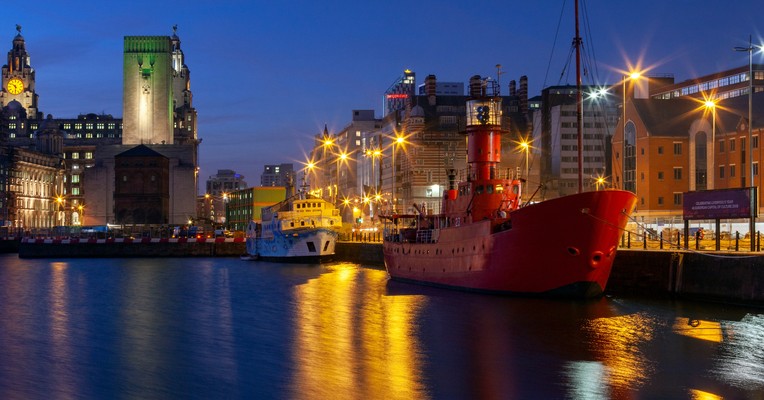 How to get ISO 42001 certification: the Liverpool waterfront at night with the Royal Liver Building and dock reflections