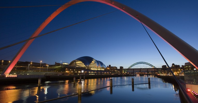 Shadow AI discovery as governance: the Gateshead Millennium Bridge arching over the River Tyne in Newcastle at blue hour
