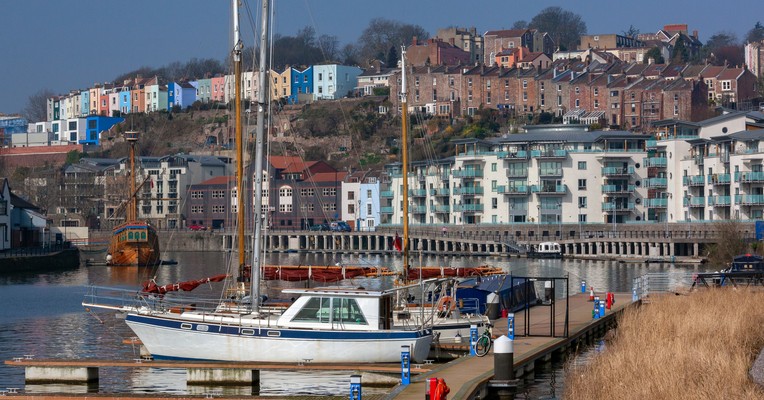 What is shadow AI: the Bristol harbourside in daylight with colourful terraced houses rising above moored boats
